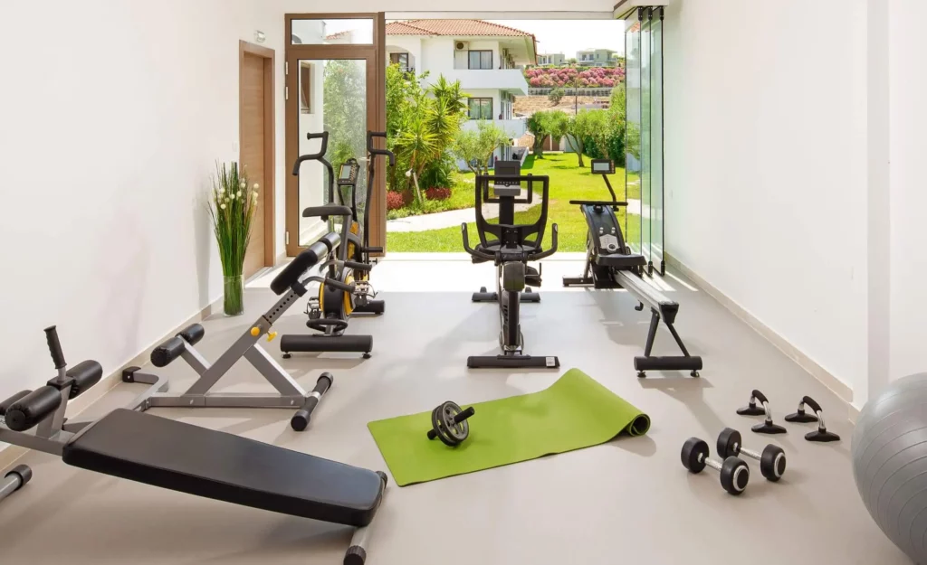 Imagem de uma academia com equipamentos modernos em uma edícula construída em casa