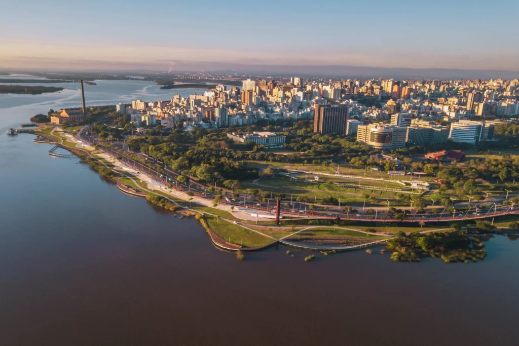 Imagem aérea de parte da cidade de Porto Alegre, com vista para lago e prédios residenciais, para ilustrar matéria sobre morar no Sul do Brasil