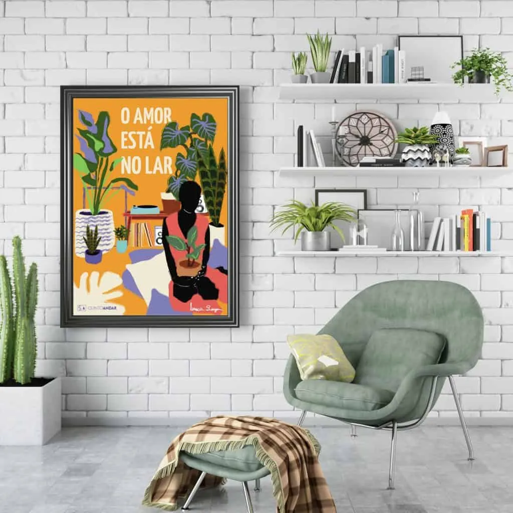 Uma sala de estar moderna com paredes de tijolos brancos, uma poltrona verde, um pufe combinando com uma manta, prateleiras de parede com plantas e decoração, e um pôster colorido do QuintoAndar Colab com os dizeres O Amor Está No Lar.